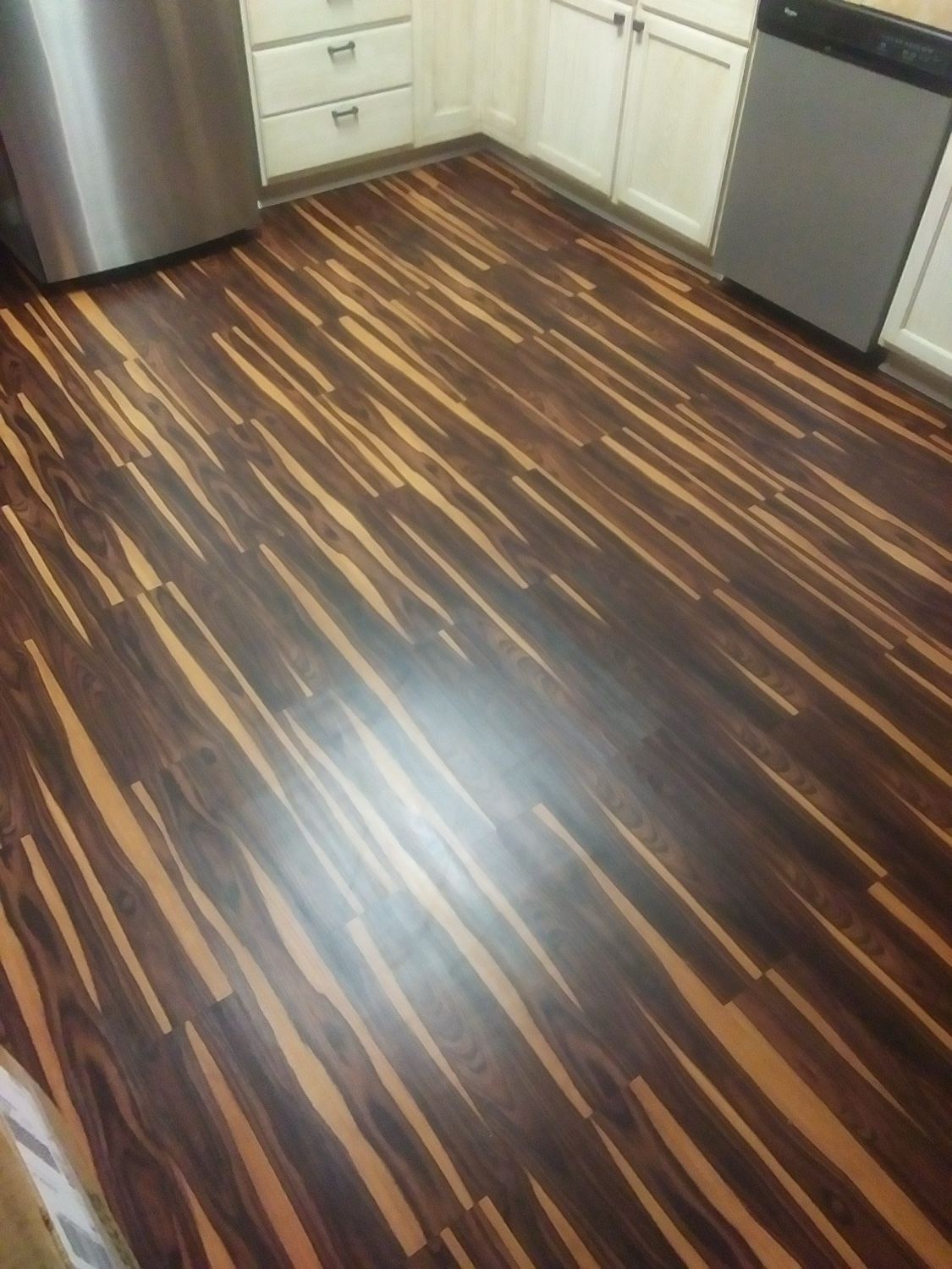 Finished kitchen with new plank flooring