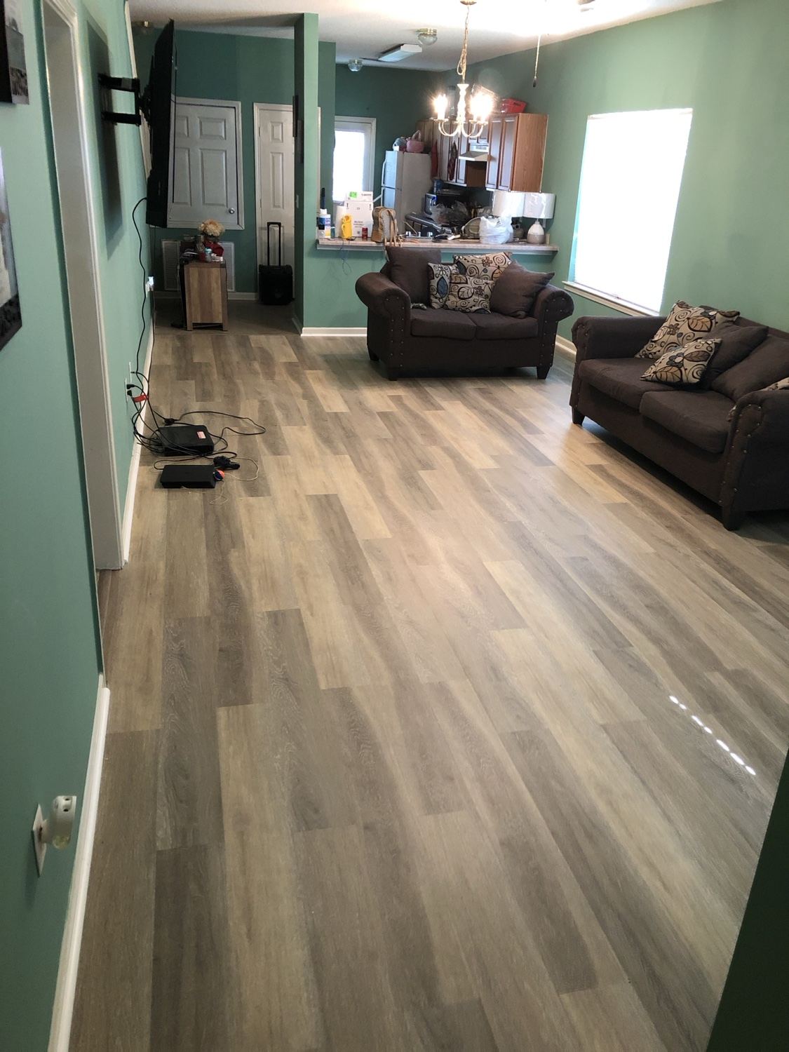 New plank flooring installed wall to wall in living room