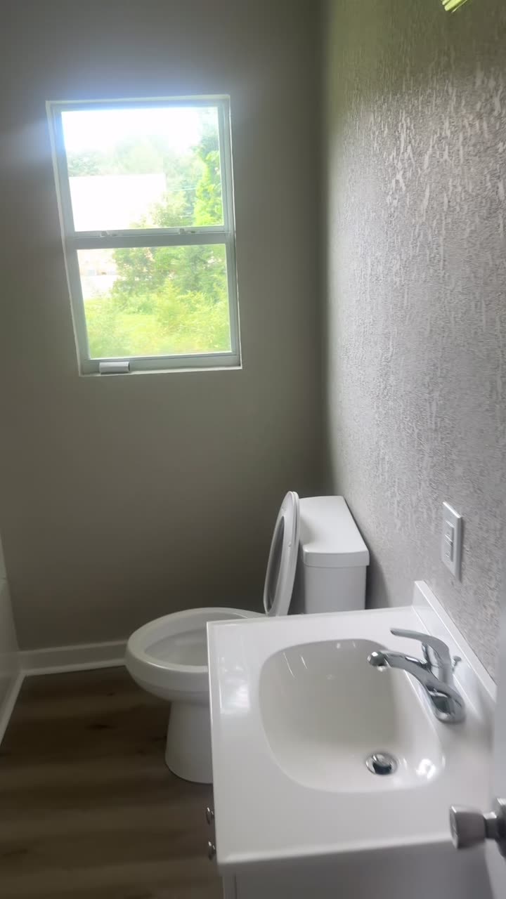Finished bathroom with new plank flooring