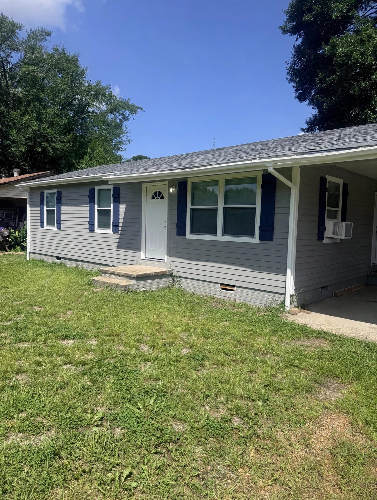 Front view with new siding, roof, and trim