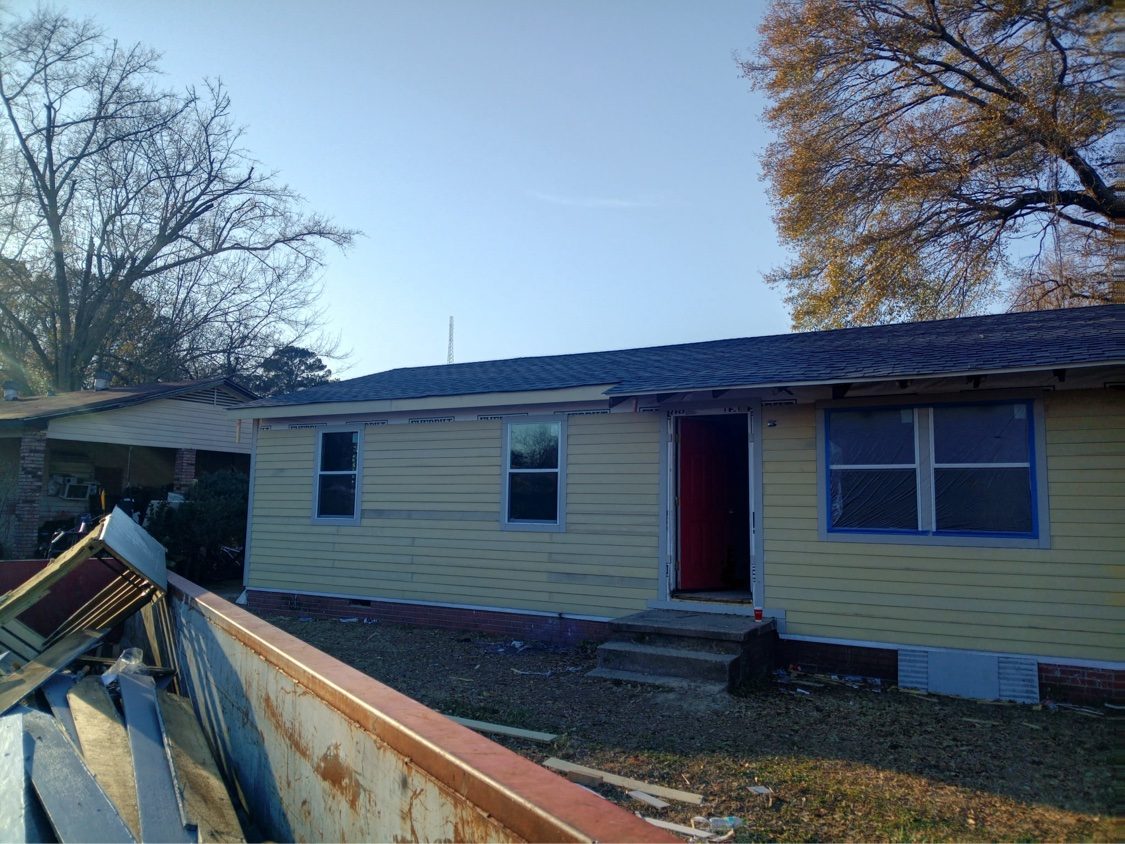 Tear-off in progress with old siding coming down