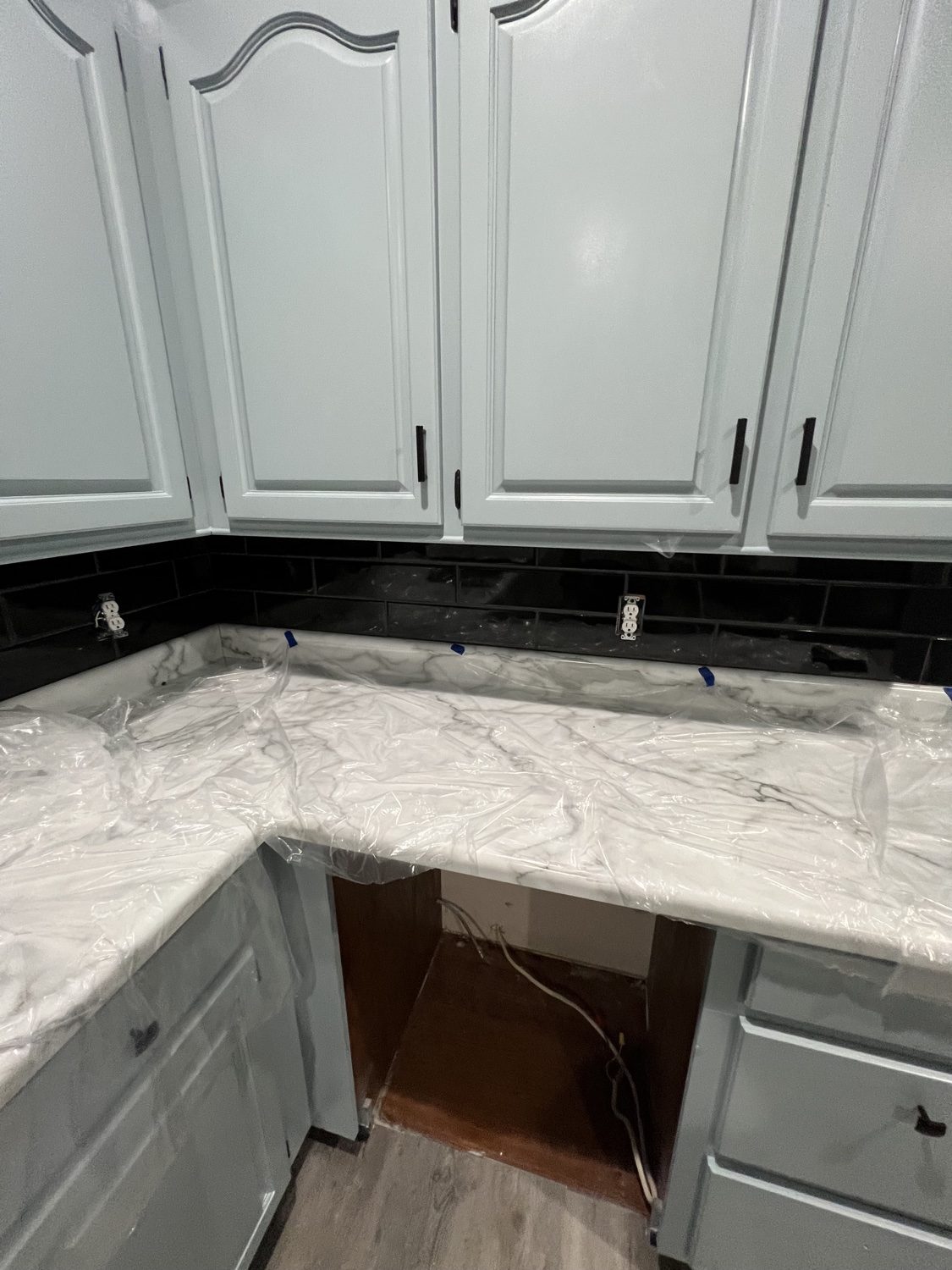 Finished kitchen with marble-look counters and refinished cabinets
