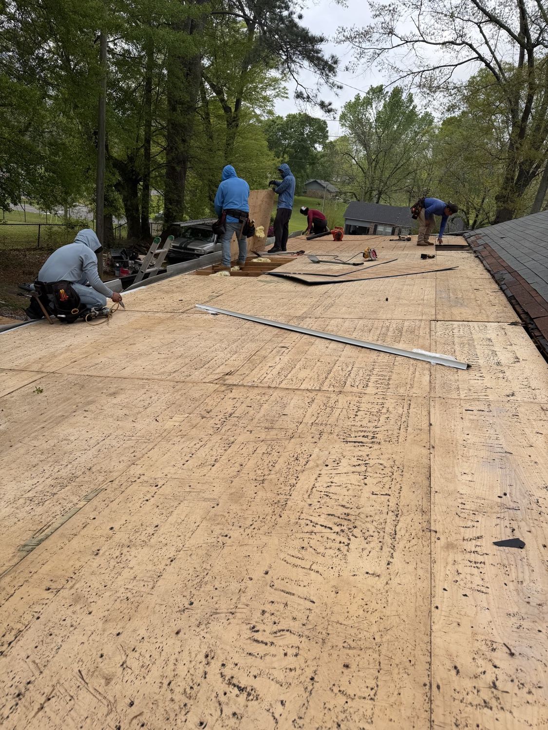 Crew installing new roof decking during a full replacement